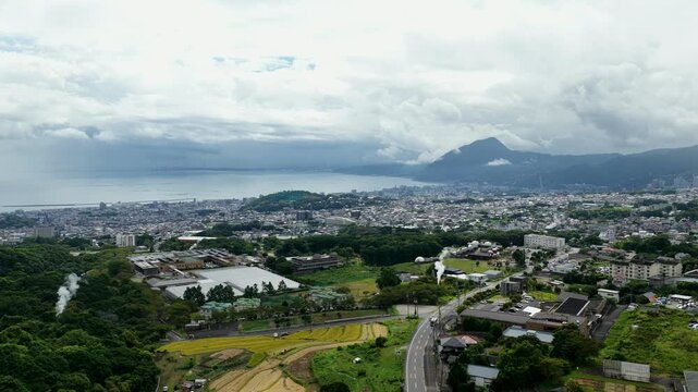 Aerial drone footage over Beppu city and bay, Oita, Japan