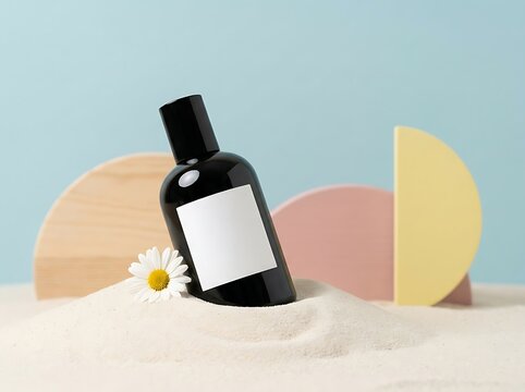 Black cosmetic bottle with blank label on sand with daisy flower and geometric shapes