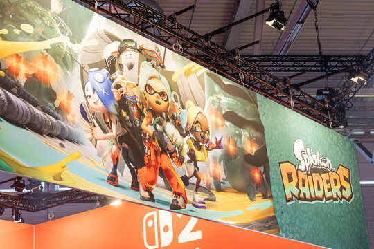 Cologne, Germany - August 26, 2026: Colorful promotional banner for Splatoon Raiders video game featuring characters in action poses at a gaming trade fair booth