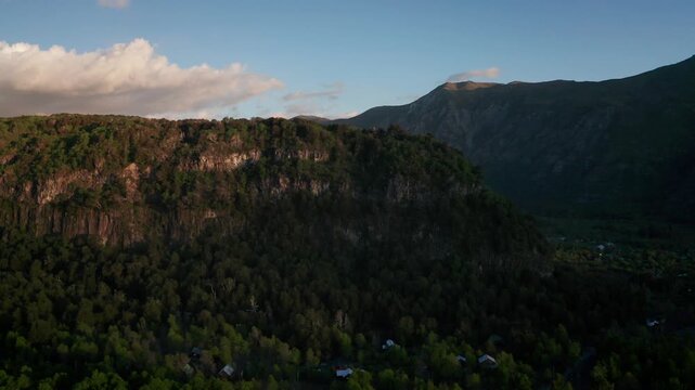Aerial view of forested mountains and rural valley landscape