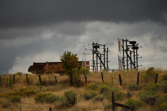 Close view of decommissioned substation disconnect switches under storm clouds in Boyd, Oregon