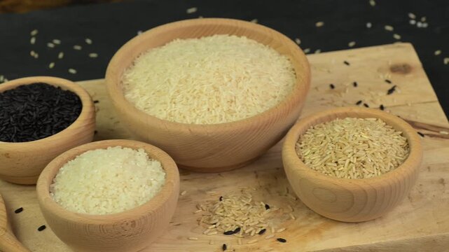 Various types of rice in wooden bowls on a table 