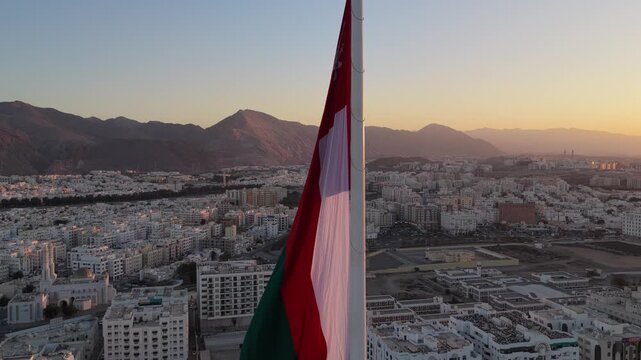 Aerial view of the Oman flag over the city of Muscat, Oman.
