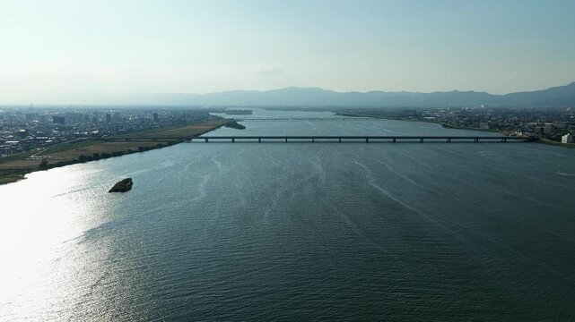 Aerial drone footage of Yoshino River and Tokushima cityscape, Japan