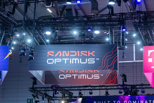 Cologne, Germany - August 26, 2026: Sandisk Optimus branding displayed prominently at gamescom trade fair with colorful lighting and modern exhibition setup visible