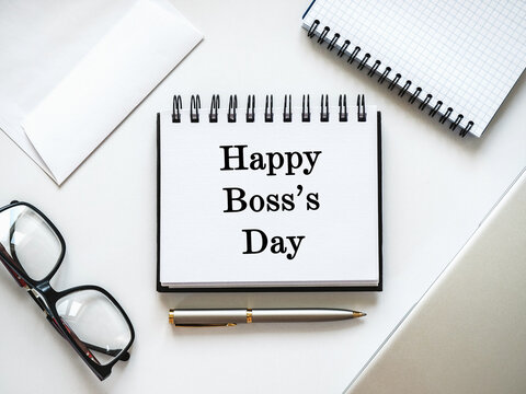 Happy Boss's Day. Desk with a calendar, notebook, and pen. Flat lay workspace. Corporate celebration and leadership appreciation. Symbolizes professional gratitude. Ideal for business content