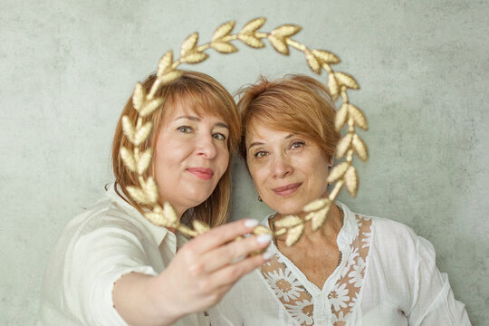 Successful women hugging, indoor portrait