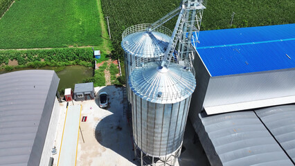 Aerial view of agricultural grain silos and blue factory building © zhu difeng