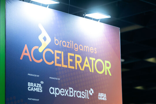Cologne, Germany - August 26, 2026: Brazil Games Accelerator promotional banner at gamescom featuring vibrant colors and logos of Brazil Games and apexBrasil