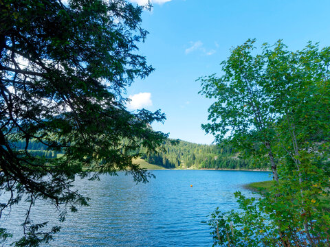Lake Spitzingsee in the Bavarian Alps seen from the forest path at the junction of Lyraweg and Rosskopfweg