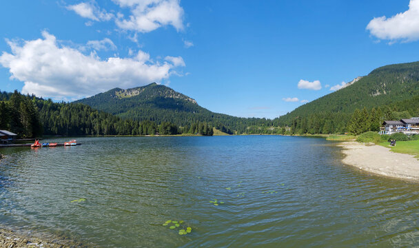 Rest area on the shores of the lake of Spitzingsee in South Bavaria, facing the summit of the Brecherspitz, overlooking the Firstgraben forest and pastures landscape
