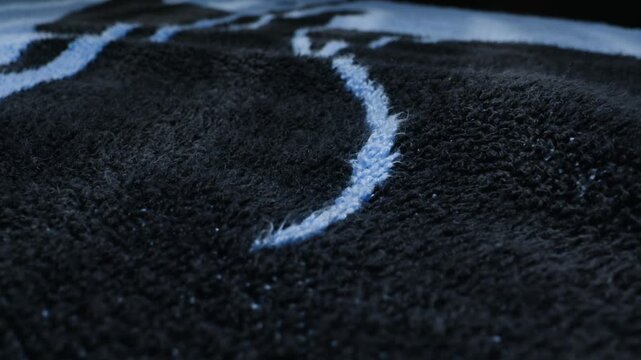 Close-up detail of a soft blue blanket or towel showing fluffy fabric texture. Concept of comfort, coziness, home textiles and softness.