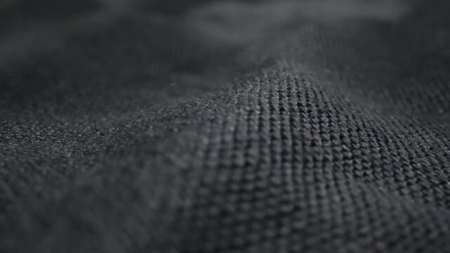 Close-up detail of a blue linen shirt showing natural fabric texture. Concept of eco-friendly clothing, natural materials and fashion.