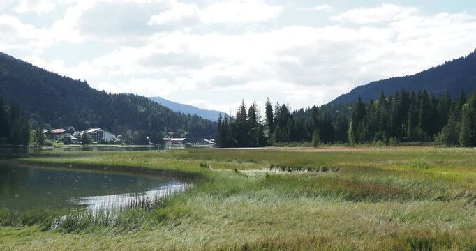 Lake Spitzingsee in the Bavarian Alps. View of the tourist resort on the eastern shore from the hiking trail around the lake
