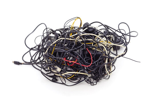 Tangled heap of electronic cables and wires isolated on a white background.