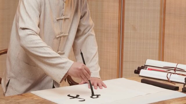 Traditional Chinese Calligraphy Writing with Brush on White Paper