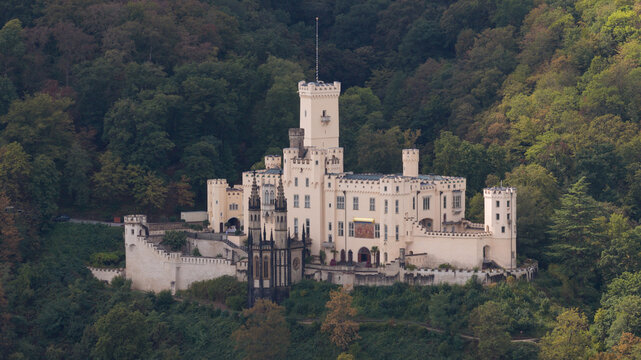 Aerial view of Stolzenfels Castle surrounded by dense forest and historic stone fortifications in Koblenz, Rheinland-Pfalz, Germany.