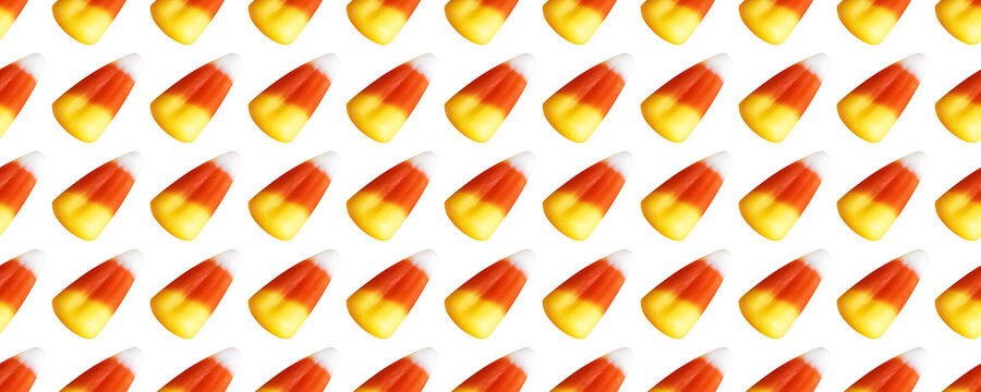 Repeating seamless pattern of candy corn pieces on transparent background	