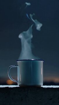 Vertical video: Releasing steam from heat, dark-rimmed white mug on concrete ledge night