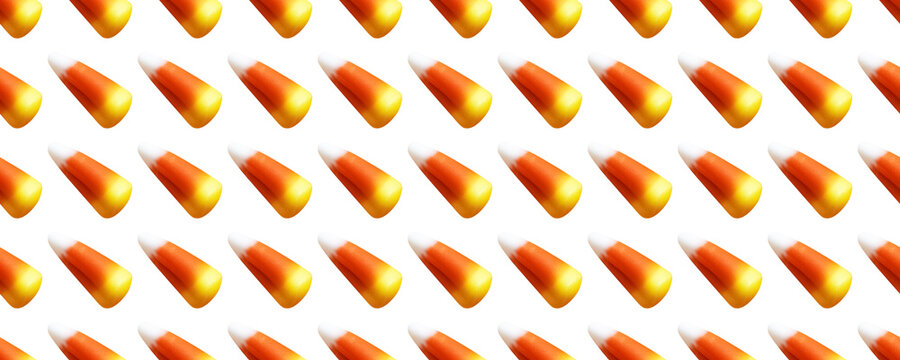 Repeating seamless pattern of candy corn pieces on transparent background	