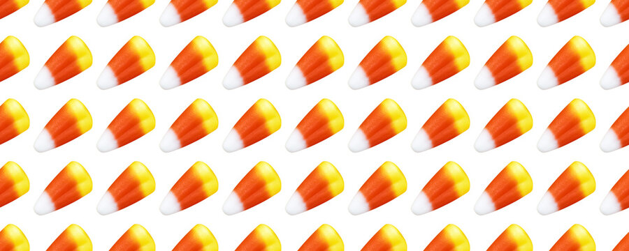 Repeating seamless pattern of candy corn pieces on transparent background	