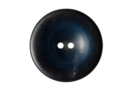 Detailed macro shot of a round textured dark blue sewing button