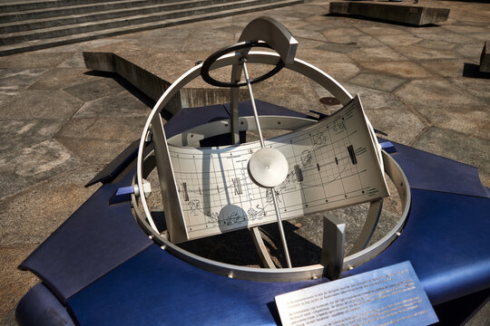Astronomical sundial with zodiac calendar, solar time instrument and gnomon, featuring armillary rings and seasonal markings for measuring time and tracking the annual solar cycle