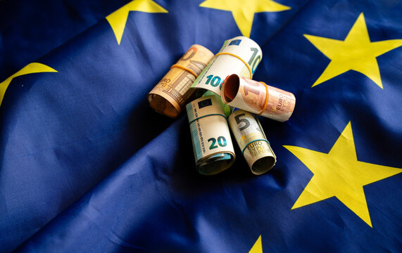 Euro banknotes cash money on European Union flag background	
