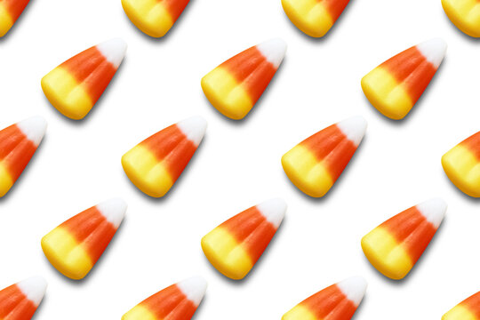 Repeating seamless pattern of candy corn pieces on transparent background	
