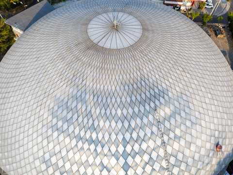 Aerial view of a large dome with a geometric diamond pattern, featuring a central circular skylight and metal framework in Boyolali, Central Java, Indonesia.