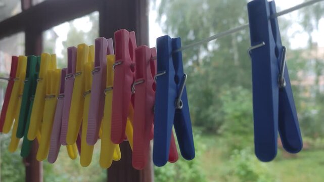 A bunch of clothes pegs hanging on a clothes line, perfect for everyday use or as a decorative item