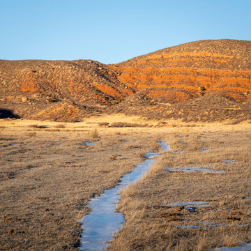 hiking and bikng trail in Red Mountain Open Space in northern Colorado, fall scenery with some snow