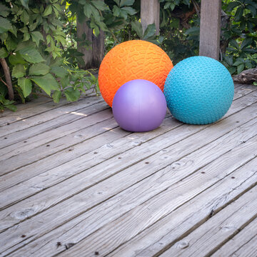 heavy slam balls filled with sand on a backyard deck, exercise and functional fitness concept
