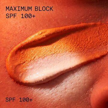 Extreme macro of orange zinc sunscreen barrier blocking harsh sun on skin texture