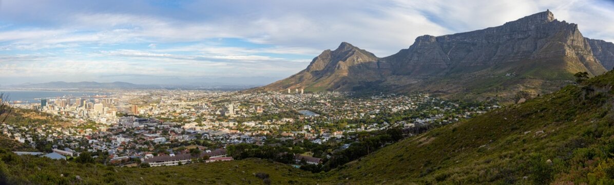 View of Table Mountain towering over the urban landscape of Cape Town, South Africa.