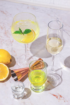 Refreshing drinks on a marble table with fresh lemons and mint leaves