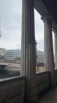 Beautiful Berlin cityscape with TV Tower, Friedrichs bridge over Spree river and giant columns near Old National gallery. Heart of old Berlin city center in typical moody rainy weather.Germany tourism