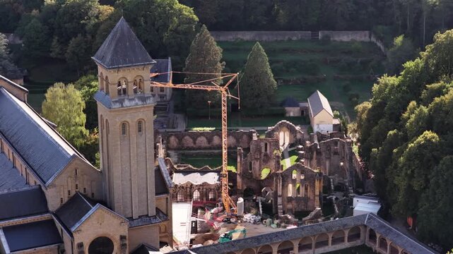 Aerial view of Orval Abbey during the day showing historic ruins and construction