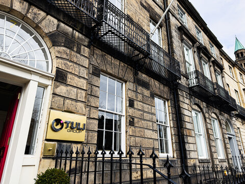 Business office Tuli Holdings Limited in a historic Georgian building with iron balconies and stone facade in Edinburgh, Scotland, UK, corporate headquarters exterior 