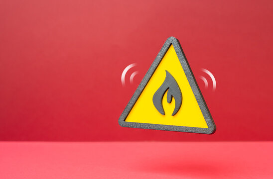 A fire hazard warning symbol. Risk of fire and flammable materials. Concept of workplace safety and industrial hazard prevention. Danger and alert.