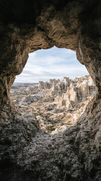 Cave opening reveals desert landscape with rock formations