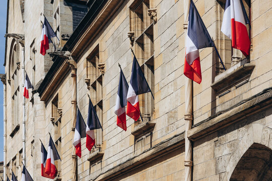 French tricolor flags displayed on the facade of the Libourne town hall in Libourne, France, on July 14, 2026