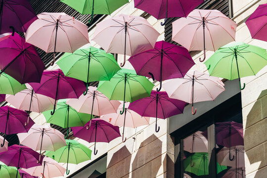 Colorful decorative umbrellas hanging above a street in central Bordeaux, France