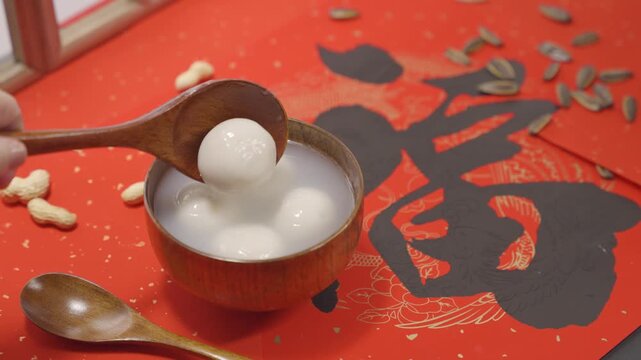 Tangyuan Rice Balls in Wooden Bowl on Red Chinese New Year Background
