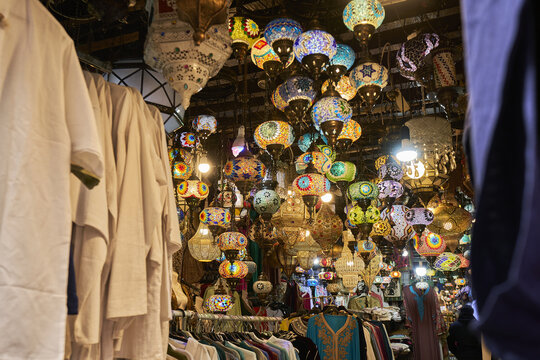 View of colorful mosaic lamps hanging in a market stall in Andalusia, Spain.