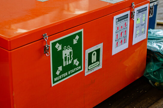 Muster station and lifejackets locker on board a vessel, clearly marked with a Muster Station sign and life-saving equipment identification signage