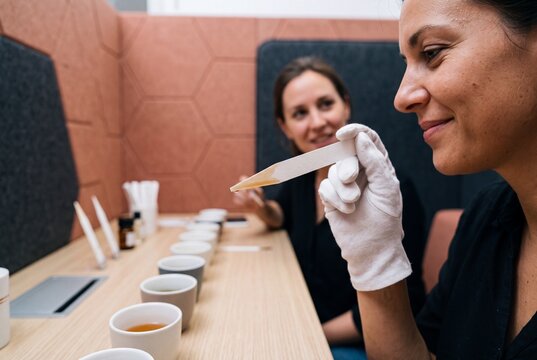 Professional perfumer evaluating fragrance sample using scent strip in sensory laboratory