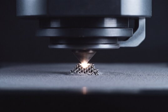 Industrial metal 3D printer head sintering powdered metal with precision laser technology to create complex component