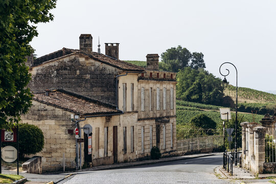 Saint Emilion, France &ndash; July 13, 2026: Historic stone houses and a quiet road overlooking vineyards on the outskirts of the Bordeaux wine town.