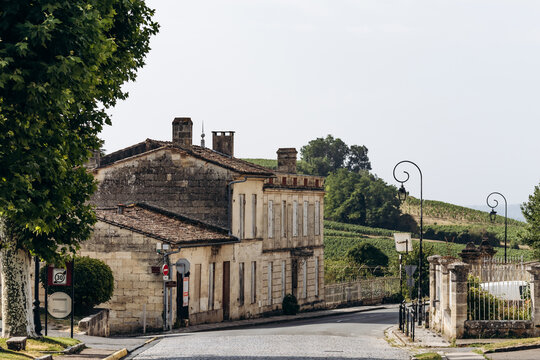 Saint Emilion, France &ndash; July 13, 2026: Historic stone houses and a quiet road overlooking vineyards on the outskirts of the Bordeaux wine town.